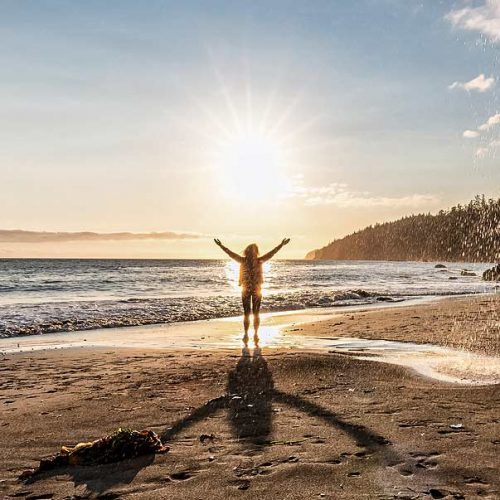 Adventurous Woman at Mystic Beach on the West Coast of Pacific Ocean. Summer Sunny Sunset. Canadian Nature Landscape Background. Located near Victoria, Vancouver Island, British Columbia, Canada.